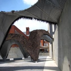 MOS's "weird furry factory" at P.S1--the thatch-covered pavilion uses the chimney effect to draw cool air through the space.