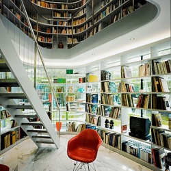 L House, designed by Philippe Steubi Architekten GMBH..."The three-sided glazing of the library in the ground floor is mirrored-glass. Depending upon time of day and lighting conditions you can see the stored books or the reflected graden..."