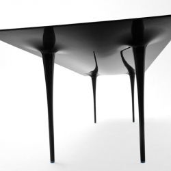 The Stealth table is an organic-shaped one-piece carbon fiber table seats up to 12.  Great for an executive boardroom or modern dining table. From the Carbon Fiber Gear store.