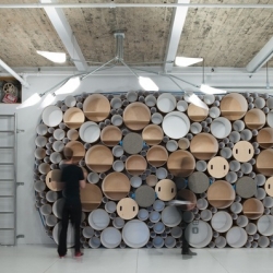 "Blue Marlin" office by SOFTlab. A creative space with a circle packed wall made of paper tubes and a flexible felt wall system.