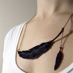 Yes, please! Miju's Wing and Prayer necklace in black acrylic with a bronze-color chain.