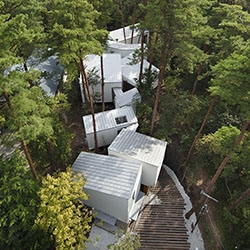 Designing this guest house in the forest of Daisen piedmont in Japan, the architects from K2 Design strove to keep the surrounding trees untouched.
