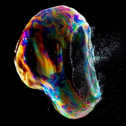 A little splash of iridescent color. Photos of bursting soap bubbles by Fabian Oefner from his new Iridient series.
