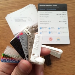 First step before ordering 3D prints should be getting Material Sample Kits! Here's a look at the design of the ones from Shapeways. Each kit has a 3D printed safety pin of sorts and samples, with corresponding info cards!