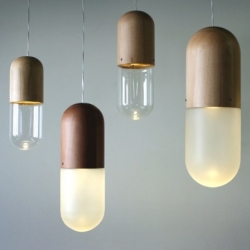 Pil by Tim Wigmore is a pill-shaped hanging lamp made of turned wood and blown glass. Between traditional know-how and today design.