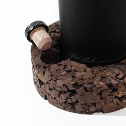 Port Wine Holder by Clinica de Arquitectura and Museu do Douro. One of the cavities is dimensioned to fit the bottle. The other is designed to land the stopper, in a way the cork does not touch the support itself.
