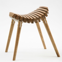 Ane stool, a solid timber stool with powder coated steel frame, formed through unique use of multiple pieces of one shape of wood positioned and cut in a dynamic way. By t-bac design.