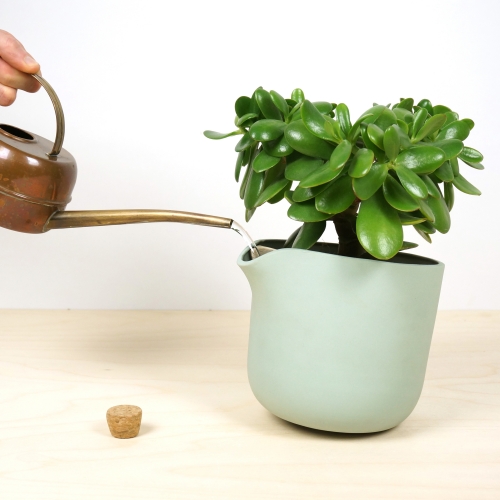 Studio Lorier's Natural Balance is a flowerpot with a water reservoir, that feeds the plant gradually. When empty, the pot tips slightly, to let you know that a refill is needed. (Currently on Kickstarter.)