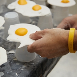 Christopher Chiappa presents a series of 7,000 handmade fried egg sculptures exhibited as a growing infestation that invades its surroundings