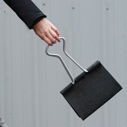 The Clip Bag by Peter Bristol is a giant version of the classic binder clip made with wool felt and aluminum tubing.