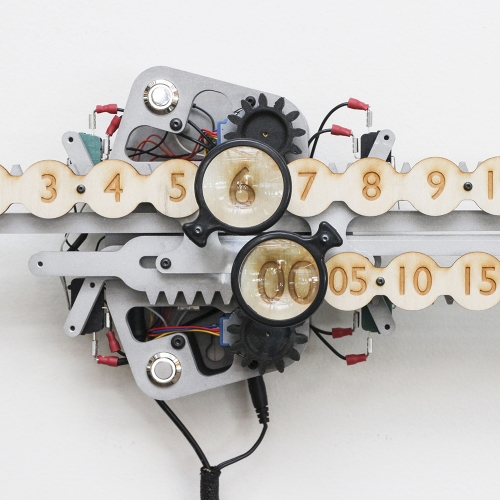 This Perpetual Clock by Jonathan Odom counts in five minute intervals to avoid the neurosis costing each minute. The hour and minute is magnified, reminding you to focus on the present.
