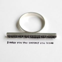 I Miss You by Colleen Baran.  Ring individually handmade of a rubber stamp and sterling silver... little traces of love left behind.