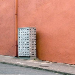 tiny, cut and paste soviet concrete-buildings affixed to electric boxes and other geometric forms all throughout europe.