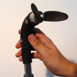 A fan combined with a walking stick. The handle slides down, reveals the fan and turns it on. two legs enable the stick to stand upright.