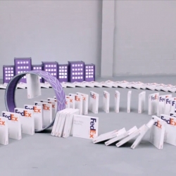 A Canada Goose ships a hockey stick to an American puppy using FedEx boxes as dominoes. 