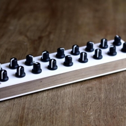 Brooklyn-based Xiwi Electronics aka Brendan Byrne manufactured a very limited run of 50 of these custom-made MIDI controllers using unfinished walnut for the sides and acrylic faceplates for the top and bottom.