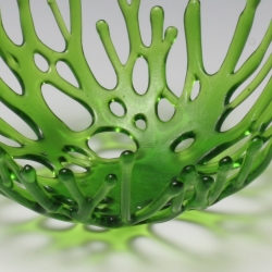 In creating these beautiful, delicate bowls, it is as if artist Heather Palmer has somehow captured the moment when liquid glass becomes solid. In green, the open latticework is like a bowl created with overlapping pieces of grass. 