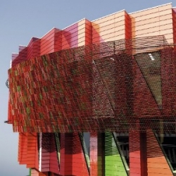 The multi-hued Kuggen Building (kuggen means cog) in Sweden features a rotating photovoltaic sun screen on the top floor designed by Winngårdh Arkitektkontor.
