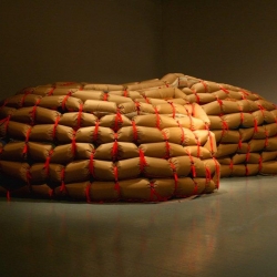 The Cozy Shelter is a inflatable hiding place that has the defensive look of a sandbag fortress from the outside. The inside is like a pastel colored cave of soft woolen blankets.  Part of the exhibition Designworld in the designmuseum of Helsinki.