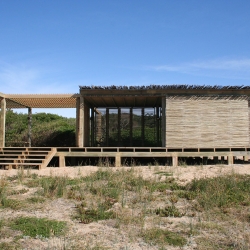 Beach pavilion is composed of a series of Eucalyptus branch panels, applied in patterns of varying density. Designed by Moorhead & Moorhead .
