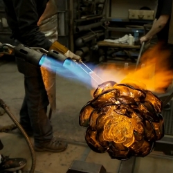 Artist Martin Blank sculpting hot glass in his Seattle studio.