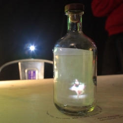 Message in a Bottle, an interactive narrative piece by a group of ITP students allows the user to move a glass bottle around a surface to explore the characters' stories. The video appears inside the bottle, projected from behind.