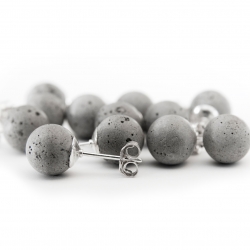 Cement earrings modeled on classic pearl studs. Each concrete sphere is cast by hand and set onto a sterling silver post. With wear, the color of earrings will deepen as the concrete is exposed to the air and the oils from your skin.