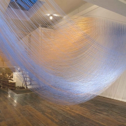 Unseen Current is a navigable billow of fog flowing through Extension Gallery. Three thousand hanging strings or "catenaries" totaling 10 miles in length span between the walls of the gallery in precise arrangements. 
