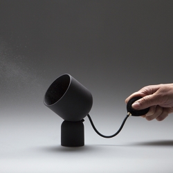 The Nebula Scent Diffuser designed by Studio WM is made of black matte porcelain and brass with a sculpture-like design that resembles a stage light and a vintage hand pump. 