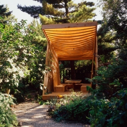 Loving this Paul Raff Studio Garden Pavilion ~ made from cedar, it has two seating banks and a table with a reflective glass top. the structure features lattice like elements that are interwoven to play with light and shadow. 