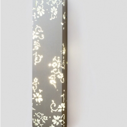 Neringa Dervinyte's Romance series lamps are made from powder-coated steel, perforated with a delicate, floral pattern. Balance of light and shadow, fragility and durability, tradition and innovation.