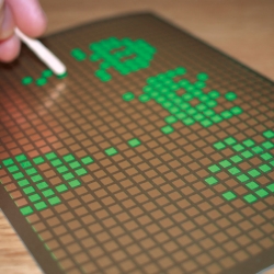 Pixel Scratch Card. Scratch away the gold foil to reveal neon green pixels.