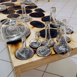 Pan Dan has some incredible images of the Droog Design hot glass on a wood table from the salone