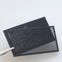 Moiré Card by Karl D. D. Willis,  an obfuscated business card that consists of two layers of laser cut material: an encoded design layer and a decoding mask layer.