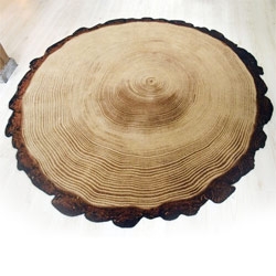 Woody Wood by Yvette Laduk (YL design) is a round carpet with a print of cross-section of a tree. The rug’s border is cut, burned and sprayed.