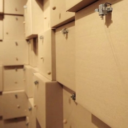 Zimoun's latest kinetic sculpture,  94 prepared dc-motors, cork balls, and cardboard boxes.