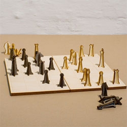 The nonessentials Chess Set by Jonas Lang, a wooden chess set in which the pieces are completely demountable. The figures can be stuck together and be dismantled as well as stored inside the chessboard.