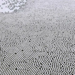 Unstable Matter by Tommi Grönlund and Petteri Nisunen, a moving table covered in thousands of ball bearings.