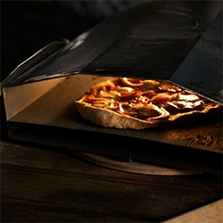 The Uuni Portable Wood-Fired Pizza Oven, a tiny wood-burning oven that weighs just 10 pounds.