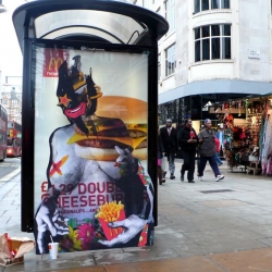 Miss Bugs are a street art duo who specialise in cutouts. This image shows an obese grotesque figure modelling the positives of Mcdonald's. It is a pardoy of both McDonalds and the Fashion Advertising