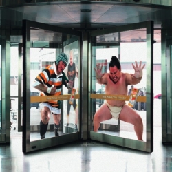 McCann Bangkok created life-sized stickers of a sumo wrestler, rugby player, judokan and wrestler, then affixed them on revolving doors to interact with the consumer with the claim "Milk makes you stronger"