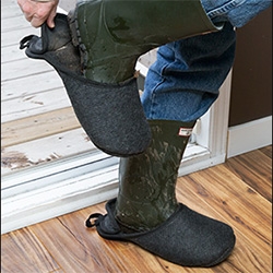 Boot Slippers - "Easy to fit over footwear, these felt overshoes let you step in from the garden for a drink without leaving a trail of wet or muddy footprints. If needed, you can lift the rubber-lined flap to help hold them against your heel."