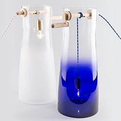 Mejd Studio's Well Lamps -  The bulb lowers like a bucket into a well. "In the case of lower positions the light becomes gradient blue while in the second variant it goes from clear transparent to sanded matte."