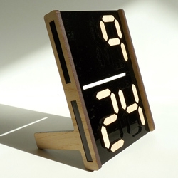 Digits desktop calendar allows the user to display the date using small pieces to form digital numerals.  Made from laser cut acrylic and mdf veneer and ships flatpack.