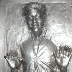 Custom Carbonite. This "lucky" fella had his mates take a mold of his head, then add it to a replica prop of Han Solo encased in carbonite. Nice.