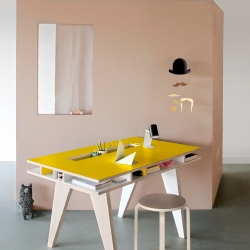 Beautiful and functional desk for a kids room, with storage space for papers, groove for pens, and an opening for computer and lightning cables to disappear.