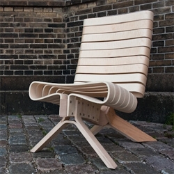 Joel Seigle's CPH 15 is a chair made entirely of beech and maple veneer. Repeated elements form harmony between the solidity of the structure and the graceful sense of comfort provided by the soft and rounded forms.