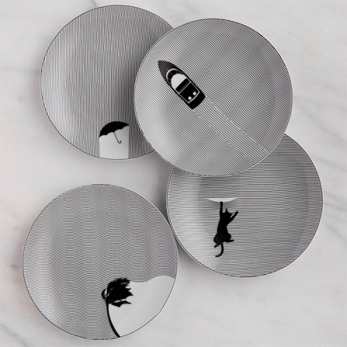 Cheeky Fine Lines Porcelain Dinnerware Collection. Such a fun collection of black and white stripes disrupted by black silhouettes (from boats and cats to birds, palm trees, and more.)