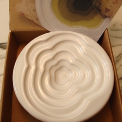 a lovely "CLOUD" olive oil dish designed by Mary Judge. when filled you see a series of concentric rings of lovely greens in descending tones due to the depth of the oil in the dish. made in italy.