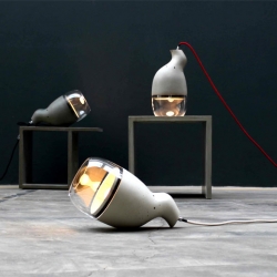 Clément Terreng and Concrete Home Design's Idee Folle is made of concrete and glass. The extravagant use of materials, asymmetrical and organic shape make this lamp so intriguing.